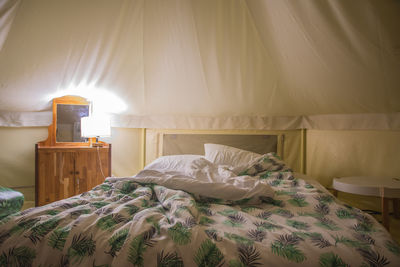 Illuminated lamp in bedroom at home