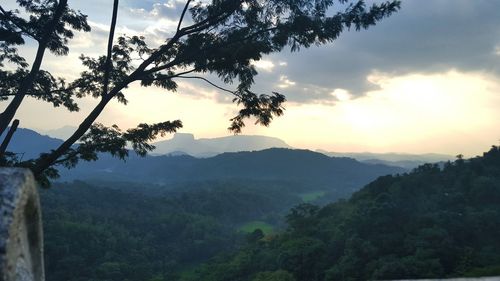 Scenic view of mountains against cloudy sky