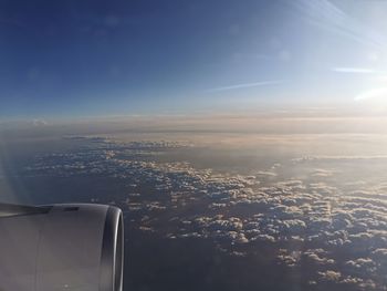 Aerial view of aircraft wing against sky