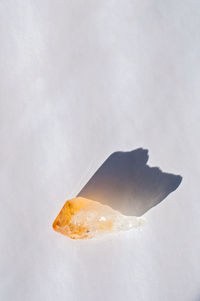 Healing orange yellow citrine stone crystal on a white table