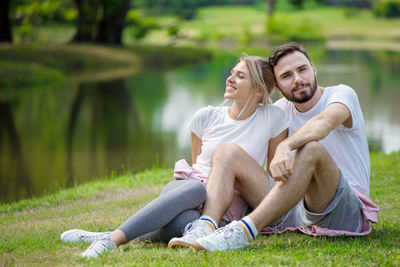 Young couple sitting outdoors
