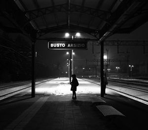 Rear view of man on railroad station platform