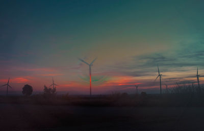 Scenic view of silhouette field against sky during sunset