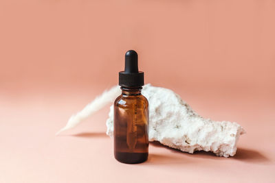 Close-up of bottle on table against gray background