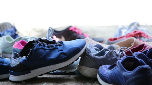 Close-up of shoes at beach