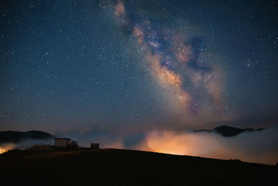 Scenic view of mountain against sky at night