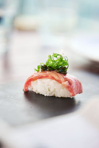 Close-up of sushi with beef and caviar on table