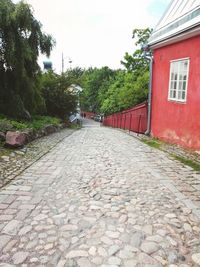 Street amidst houses against sky