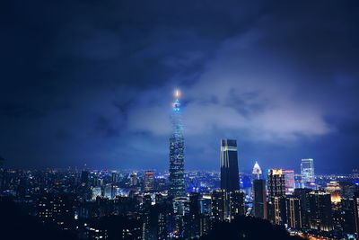 Illuminated cityscape against sky at night