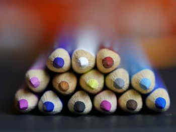 Close-up of multi colored pencils on table