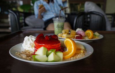 Close-up of fruits in plate on table