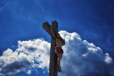 Low angle view of statue against blue sky