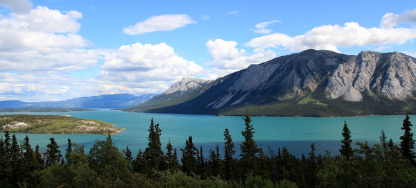 Scenic view of mountains against cloudy sky