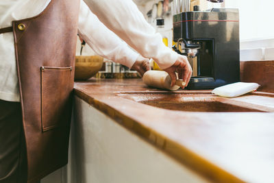 Midsection of woman preparing food at home