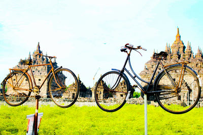 Bicycles on field against sky