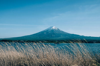 Scenic view of mountains against blue sky