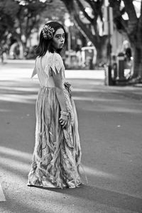 Woman standing on street in city