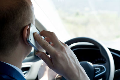 Portrait of young man in car