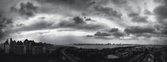 Cityscape against cloudy sky