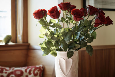 Close-up of roses in vase on table at home