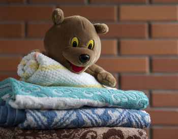 Close-up of stuffed toy against wall