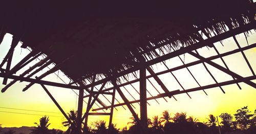 Low angle view of built structure at sunset