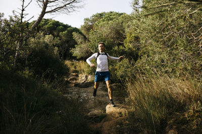 Full length of young man running on grass