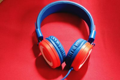 Close-up of headphones on red seat