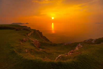 Scenic view of sea against orange sky