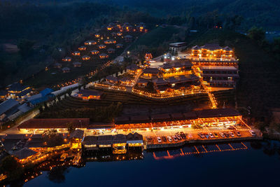 High angle view of illuminated buildings in city at night