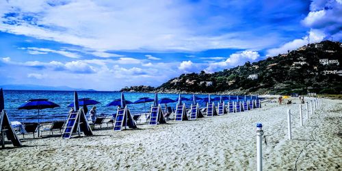 Scenic view of beach against blue sky