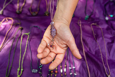 Close-up of hands holding purple