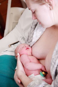 Mother with newborn on bed