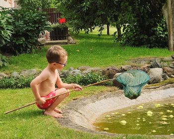 Full length of shirtless boy in water