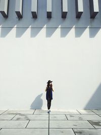 Woman standing against wall