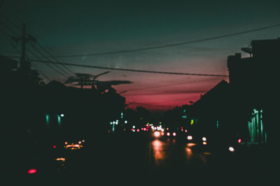 Illuminated city against sky at night