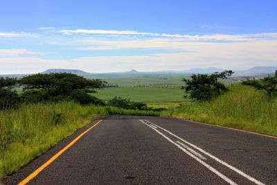 Road passing through landscape against sky