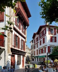People on street amidst buildings in city