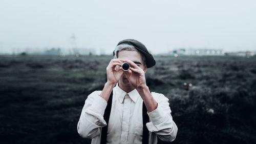 Man photographing on field