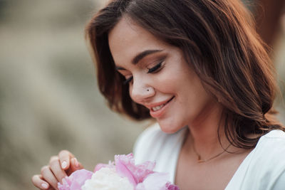 Close-up portrait of smiling young woman