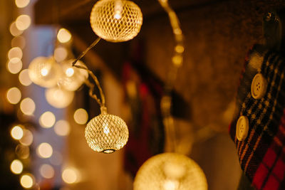 Close-up of illuminated christmas lights hanging on wood