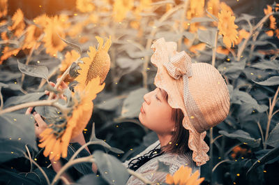 Close-up of woman looking at plants