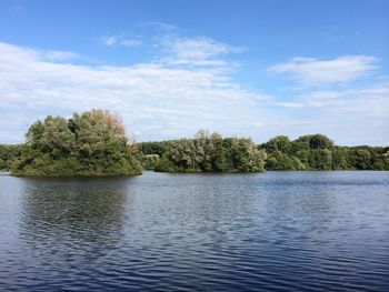 Scenic view of lake against cloudy sky