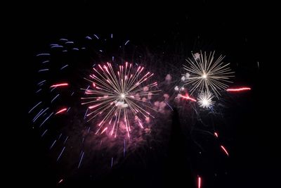 Low angle view of firework display at night