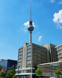 Low angle view of communications tower against blue sky