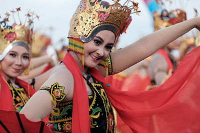 Portrait of smiling young woman in traditional clothing during festival