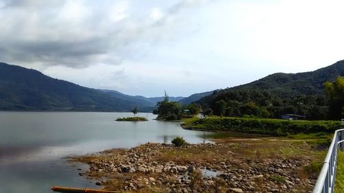 Scenic view of lake and mountains against sky