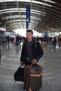 Portrait of man standing at railroad station