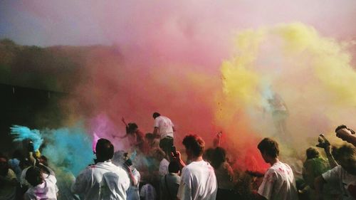 People enjoying with multi colored powder paints in festival