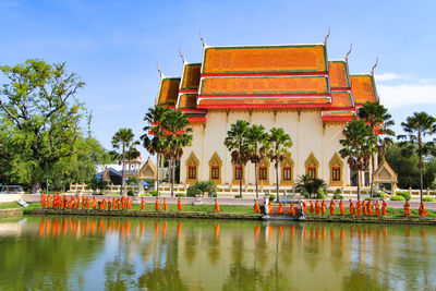 Exterior of building by lake against sky